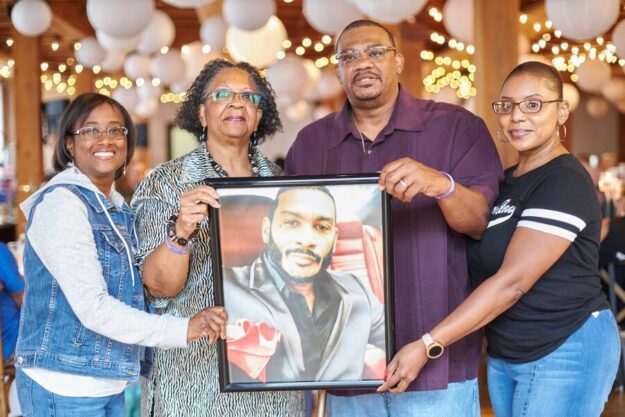 Donor family hold picture of donor man at the Celebration Of Life Greenhouse