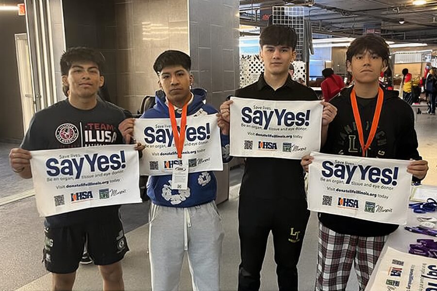 Teen wrestlers holding say yes towel