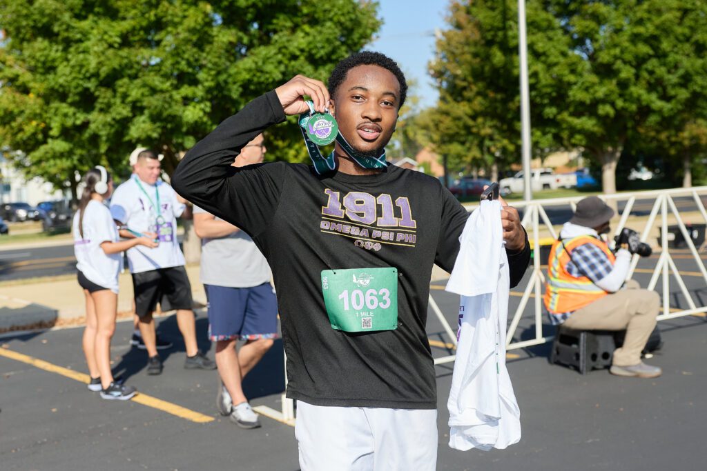Runner holding medal
